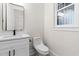 A traditional half bath includes white cabinets, marble counter, and black hardware at 2205 Yellow Morel Way, Myrtle Beach, SC 29579