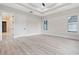 An airy bedroom featuring recessed lights, a ceiling fan, tray ceiling and large windows at 2205 Yellow Morel Way, Myrtle Beach, SC 29579