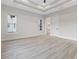 Bright bedroom with large windows, a tray ceiling and an ensuite bathroom and closet at 2205 Yellow Morel Way, Myrtle Beach, SC 29579