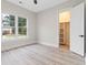 A light-filled bedroom shows light vinyl floors, walk-in closet, and a double window at 2205 Yellow Morel Way, Myrtle Beach, SC 29579