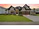 Charming two-story home featuring a landscaped yard, a two-car garage, and stone veneer accents at 2205 Yellow Morel Way, Myrtle Beach, SC 29579