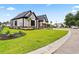 Charming home featuring a well-kept lawn, stone accents, and a side-entry garage at 2205 Yellow Morel Way, Myrtle Beach, SC 29579