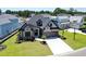 Aerial front view of a grey home with a manicured lawn and brown garage doors at 2205 Yellow Morel Way, Myrtle Beach, SC 29579