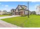 Beautiful home showcasing stone accents, a well-manicured lawn, and a two-car garage at 2205 Yellow Morel Way, Myrtle Beach, SC 29579