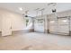 A three car garage features white walls, windows, and concrete floors at 2205 Yellow Morel Way, Myrtle Beach, SC 29579
