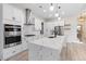 Modern kitchen with stainless steel appliances, a waterfall island, and white cabinets at 2205 Yellow Morel Way, Myrtle Beach, SC 29579