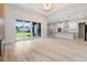 Bright, open-concept living space with hardwood floors, modern lighting, and sliding glass doors to a spacious backyard at 2205 Yellow Morel Way, Myrtle Beach, SC 29579