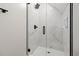 A frameless shower features marble tile, a rain head, and black trim at 2205 Yellow Morel Way, Myrtle Beach, SC 29579