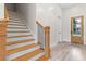Open staircase with wood treads, black iron balusters, and luxury vinyl plank flooring at 2205 Yellow Morel Way, Myrtle Beach, SC 29579