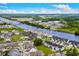 An aerial view showcases condos along the river, a bridge, community pool and lush green landscaping at 222 Landing Rd. # 1811, North Myrtle Beach, SC 29582