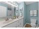 Bathroom featuring a dual sink vanity, a toilet, and coordinated blue walls at 222 Landing Rd. # 1811, North Myrtle Beach, SC 29582