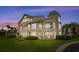 Exterior dusk view of the condo featuring a screened porch with large windows for natural light and outdoor enjoyment at 222 Landing Rd. # 1811, North Myrtle Beach, SC 29582