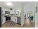 Well-lit kitchen featuring white cabinets, stainless steel appliances, and seamless view into the living space at 222 Landing Rd. # 1811, North Myrtle Beach, SC 29582