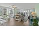 Bright living room with large windows, ceiling fan, hardwood floors, and stylish furnishings at 222 Landing Rd. # 1811, North Myrtle Beach, SC 29582