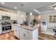 Modern kitchen with white cabinets, granite countertops, stainless steel appliances, and an island with pendant lighting at 227 Sundrop Way, Conway, SC 29526