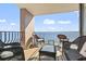 Relaxing balcony area with stunning ocean views featuring wicker seating and a glass table at 2500 N Ocean Blvd. # Ph 1, Myrtle Beach, SC 29577