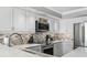 This modern kitchen features quartz countertops, stainless appliances, and mosaic tile backsplash at 2500 N Ocean Blvd. # Ph 1, Myrtle Beach, SC 29577