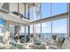 Bright living room featuring high ceilings, stylish decor, and floor-to-ceiling windows with ocean views at 2500 N Ocean Blvd. # Ph 1, Myrtle Beach, SC 29577