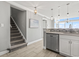 Open floor plan kitchen with stainless steel appliances and breakfast bar near stairway at 2500 N Ocean Blvd. # Ph 1, Myrtle Beach, SC 29577
