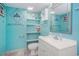 Bathroom featuring blue walls, shelving, toilet, vanity, sink and mirror at 2801 S Ocean Blvd. # 535, North Myrtle Beach, SC 29582