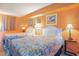 Bedroom featuring two beds, lamps, wall art, and orange-painted walls at 2801 S Ocean Blvd. # 535, North Myrtle Beach, SC 29582