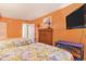 Comfortable bedroom with beds, dresser, TV, and vibrant orange walls at 2801 S Ocean Blvd. # 535, North Myrtle Beach, SC 29582
