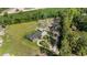 An aerial view of a home with a long driveway, an in-ground pool, large lot and green agricultural fields nearby at 2981 Victor Rd., Longs, SC 29568