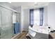 Bright bathroom featuring a glass shower, jetted tub, and blue accents, creating a spa-like retreat at 2981 Victor Rd., Longs, SC 29568
