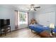 Cozy bedroom with soft natural light, featuring a ceiling fan, and ample storage at 2981 Victor Rd., Longs, SC 29568