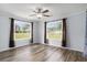 Inviting bedroom featuring neutral walls, wood-look floors, and windows with sheer curtains at 2981 Victor Rd., Longs, SC 29568