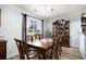 Traditional dining room with wood table, chairs, cabinet and window view of outdoors at 2981 Victor Rd., Longs, SC 29568