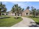 Charming brick home with a curved driveway, mature landscaping, and a lush green lawn at 2981 Victor Rd., Longs, SC 29568