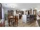 Open-concept kitchen and dining area with dark wood cabinets, stainless steel appliances and bar seating at 2981 Victor Rd., Longs, SC 29568