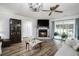 Cozy living room featuring a fireplace with a mounted TV, ceiling fan and sliding glass doors at 2981 Victor Rd., Longs, SC 29568
