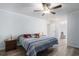 Comfortable main bedroom with ceiling fan, wood-look flooring, and a bedside table at 2981 Victor Rd., Longs, SC 29568