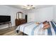 Main bedroom with wood-look flooring, ceiling fan, and dresser with mirror at 2981 Victor Rd., Longs, SC 29568
