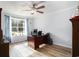Well-lit home office with a ceiling fan, desk and large window at 2981 Victor Rd., Longs, SC 29568