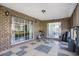 Enclosed brick patio with ample space for outdoor activities, providing shade and natural light at 2981 Victor Rd., Longs, SC 29568