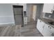 Well-lit kitchen with stainless steel appliances, granite countertops, white cabinets, and modern flooring at 300 47Th Ave. S # 1F, North Myrtle Beach, SC 29582
