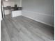 Open-concept living area with light gray hardwood floors, adjacent to a modern kitchen at 300 47Th Ave. S # 1F, North Myrtle Beach, SC 29582