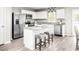 Bright kitchen boasts white cabinets, stainless appliances, a granite island, and a stylish breakfast bar at 3210 Nw Edgemead Circle # C, Calabash, NC 28467