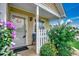 Charming home entrance with decorative flower bushes, a white picket fence, and covered front porch at 403 Chesterfield Ct., Myrtle Beach, SC 29577