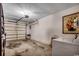 Spacious garage area with overhead door, utility sink, and space for storage or projects at 403 Chesterfield Ct., Myrtle Beach, SC 29577