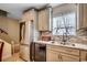 Well-lit kitchen features stainless steel appliances, granite countertops, tile backsplash, and gray cabinetry at 403 Chesterfield Ct., Myrtle Beach, SC 29577