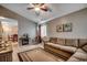 Cozy living room with neutral tones, tile flooring, ceiling fan, and comfortable seating at 403 Chesterfield Ct., Myrtle Beach, SC 29577
