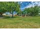 Enjoy this expansive green space with playground equipment, mature trees, and clear blue skies at 403 Chesterfield Ct., Myrtle Beach, SC 29577