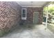 Spacious carport featuring brick walls and concrete flooring at 41 Harmon St., Hemingway, SC 29554