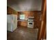 Kitchen featuring wood cabinets, white appliances, and a window over the sink at 41 Harmon St., Hemingway, SC 29554