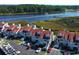 Aerial view showcasing the townhome community, lush landscape, parking, and boat access to the river at 4396 Baldwin Ave. # 1, Little River, SC 29566