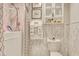 Clean bathroom featuring a shower over tub, decorative tile, and a shelf for storage at 4396 Baldwin Ave. # 1, Little River, SC 29566